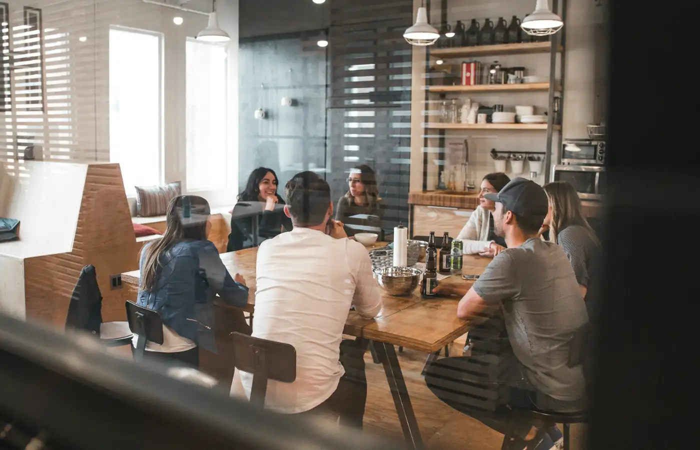 A group working together around a long table in a daylit office